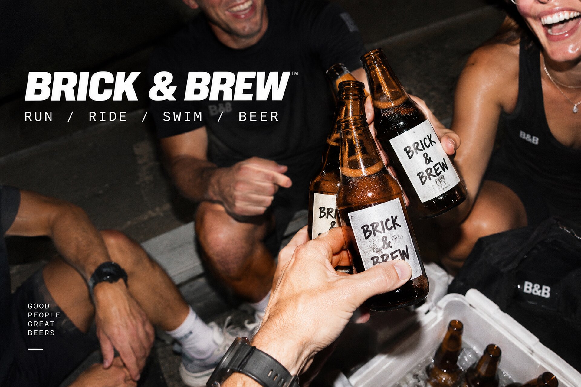A crew sitting on the pavement at night, clinking Brick and Brew bottles over an open cooler. The still already carries the wordmark.